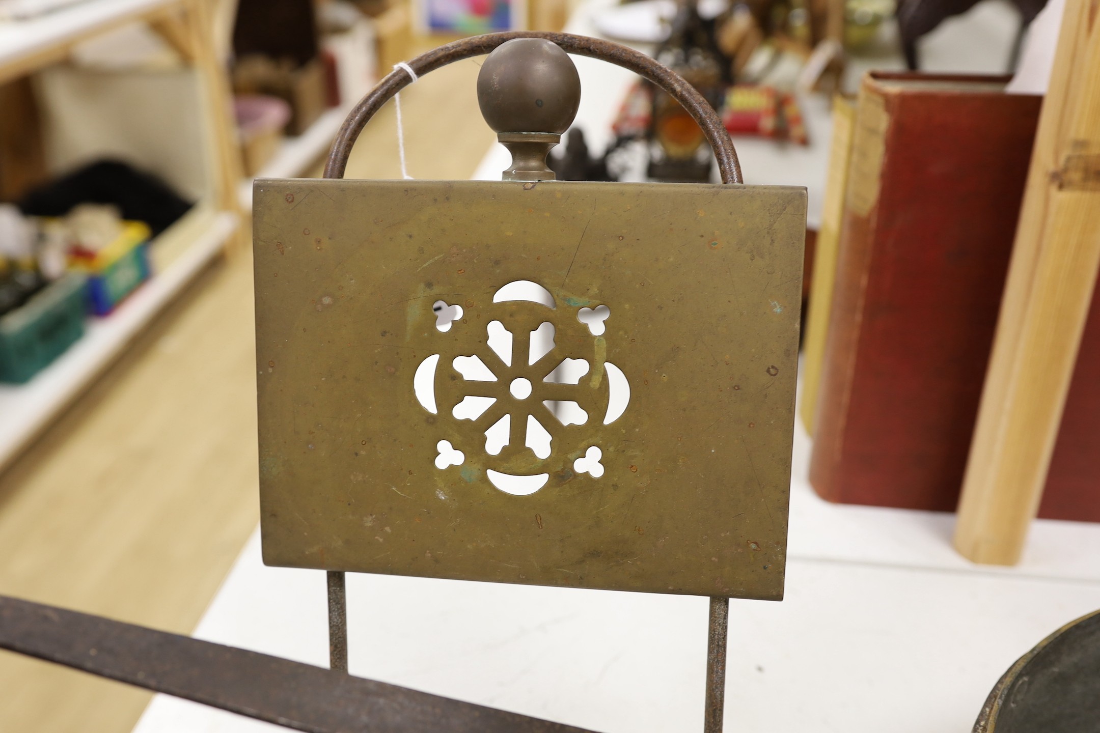 Two brass grate trivets, a crystal and brass towel rail and a 19th century copper pot
